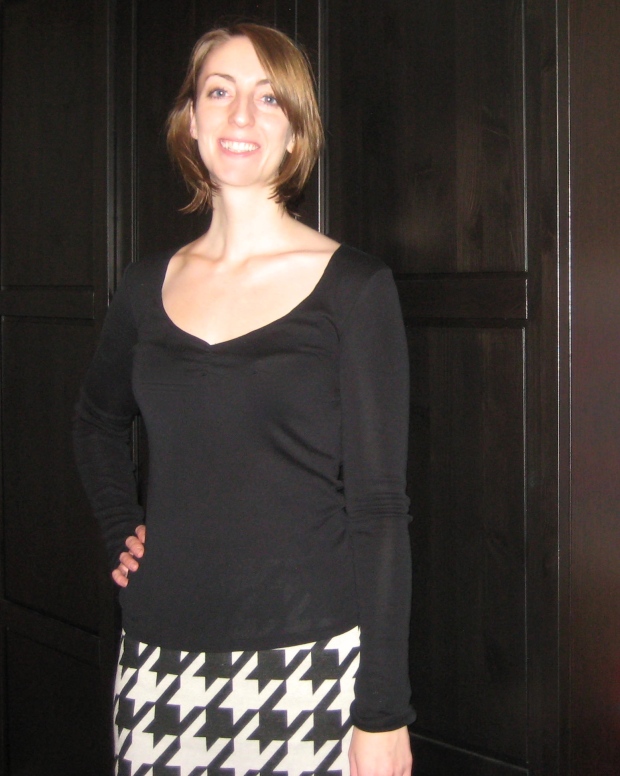 black v-neck top with black and white geometric skirt